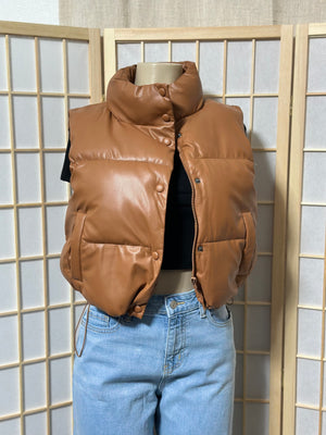The “Trendsetting” Faux Leather Puffer Vest In Brown