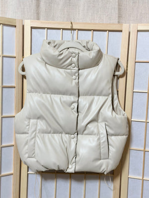 The “Trendsetting” Faux Leather Puffer Vest In Ivory